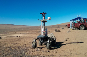 Space rover robot on open plain dirt environment. 