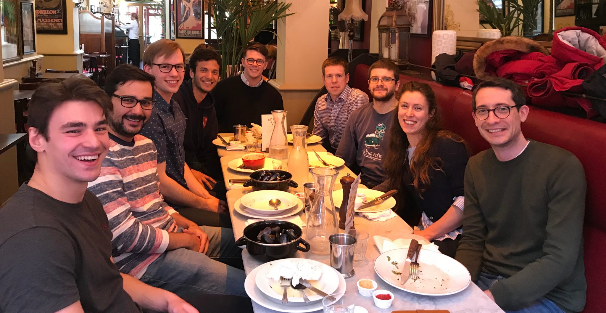 Group photo of Dynamic Robot Systems group having a meal in a restaurant