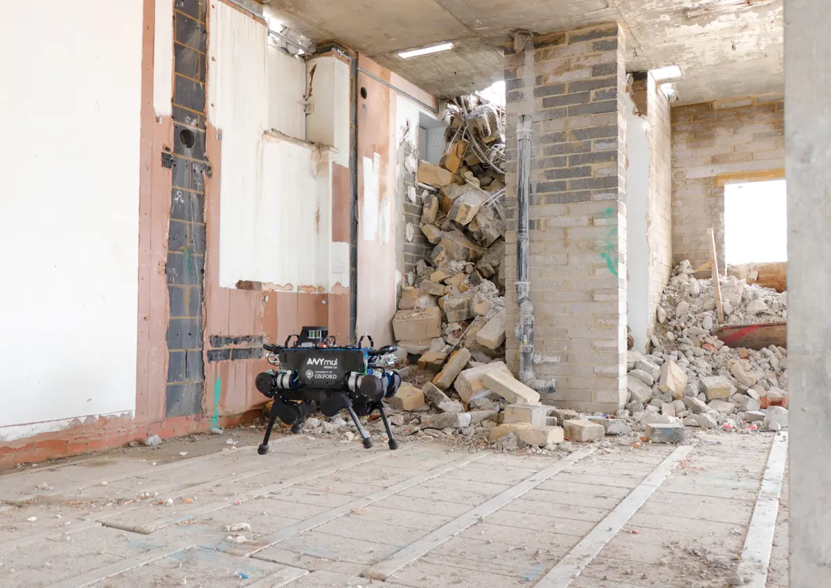 Blue ANYmal B robot in front of building rubble.